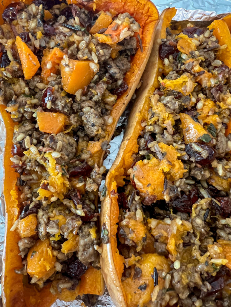 The sausage mixture has been added to the hallowed shells of the squash for baking.