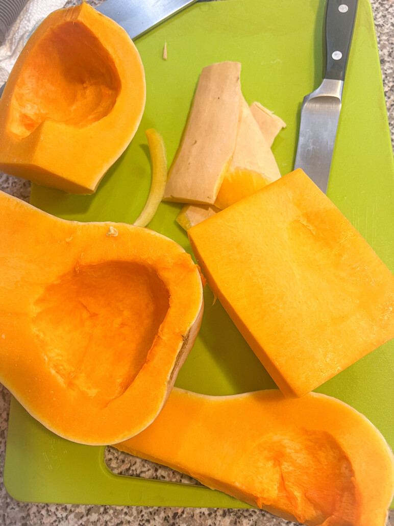 Peeling and cutting the butternut squash on a bright green cutting board.
