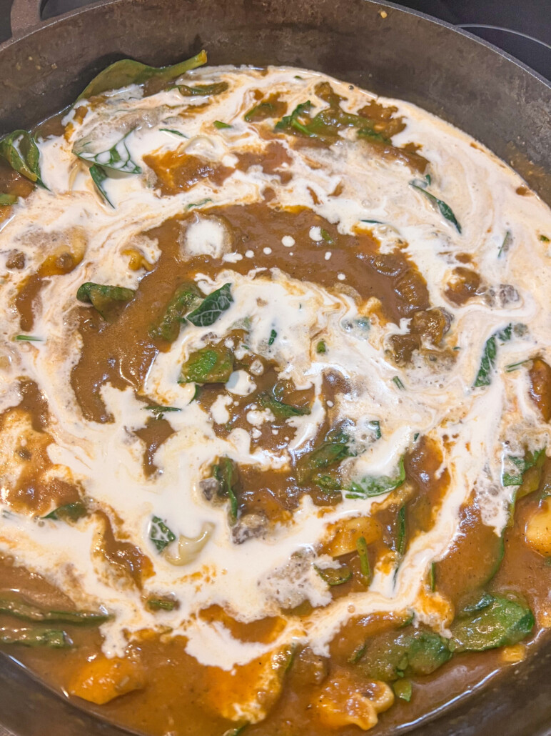 Heavy cream is being incorporated into the soup.