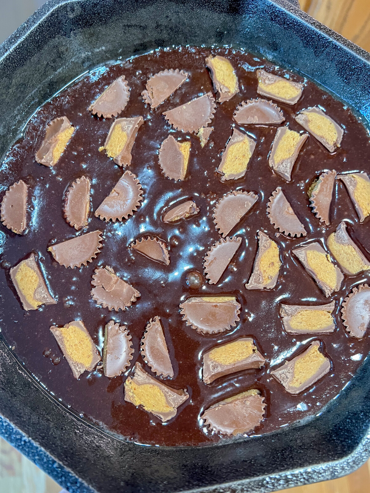Mini peanut butter cup candy cut in have and placed into the brownie batter.
