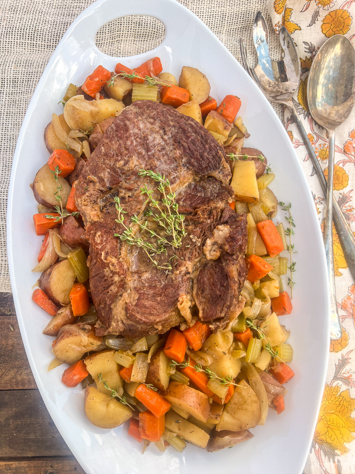 Dutch oven beef roast with carrots, onions, potatoes, and celery.