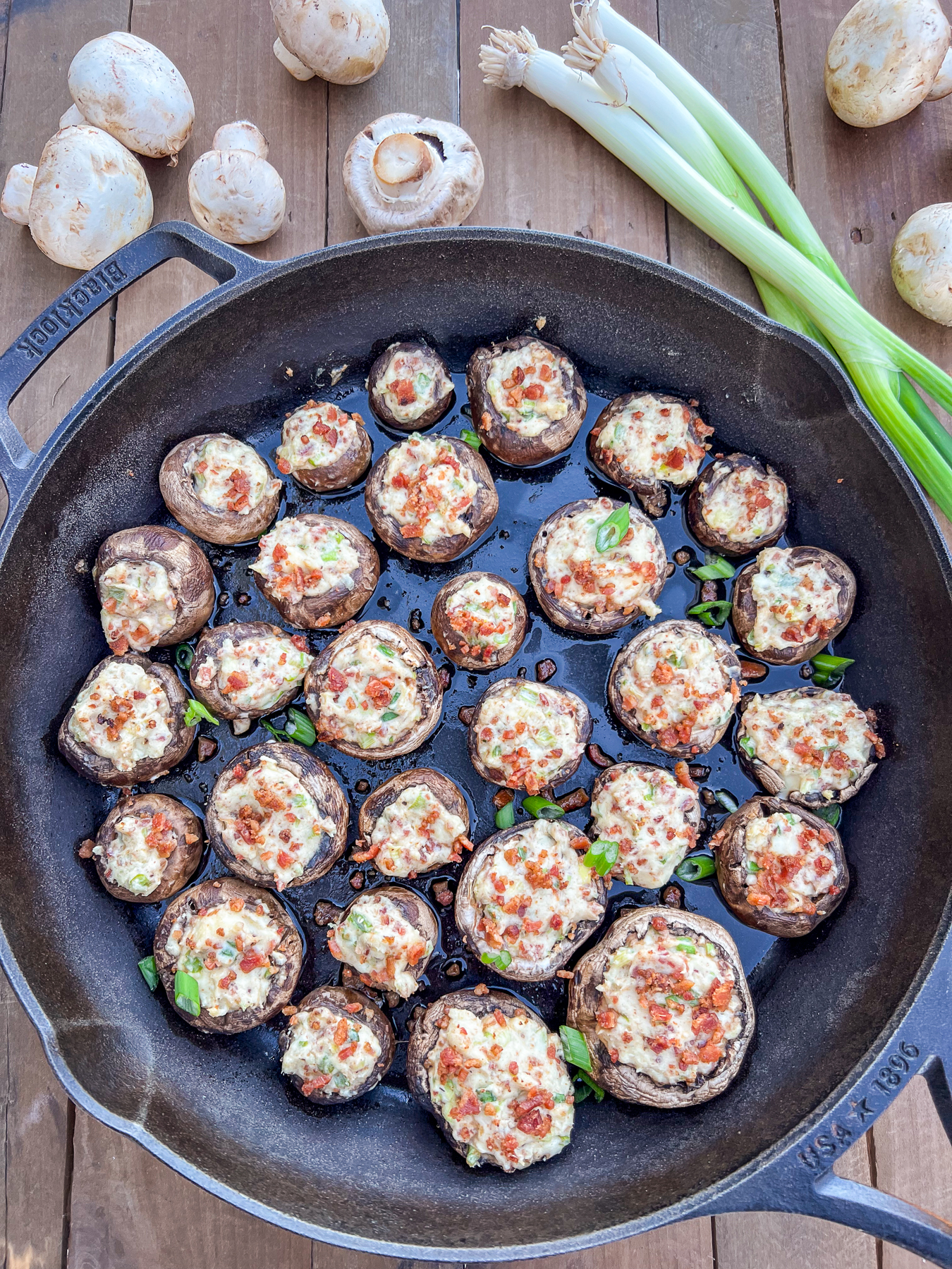 Cream cheese mushrooms displayed in a cast iron skillet.