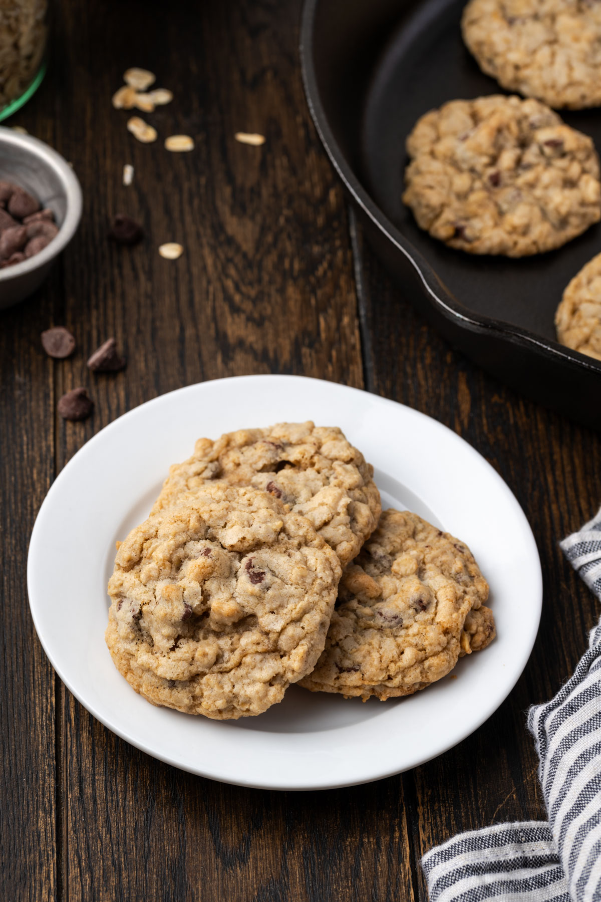 Oatmeal Chocolate Chip Cookies on a plate and in a cast iron skillet. 