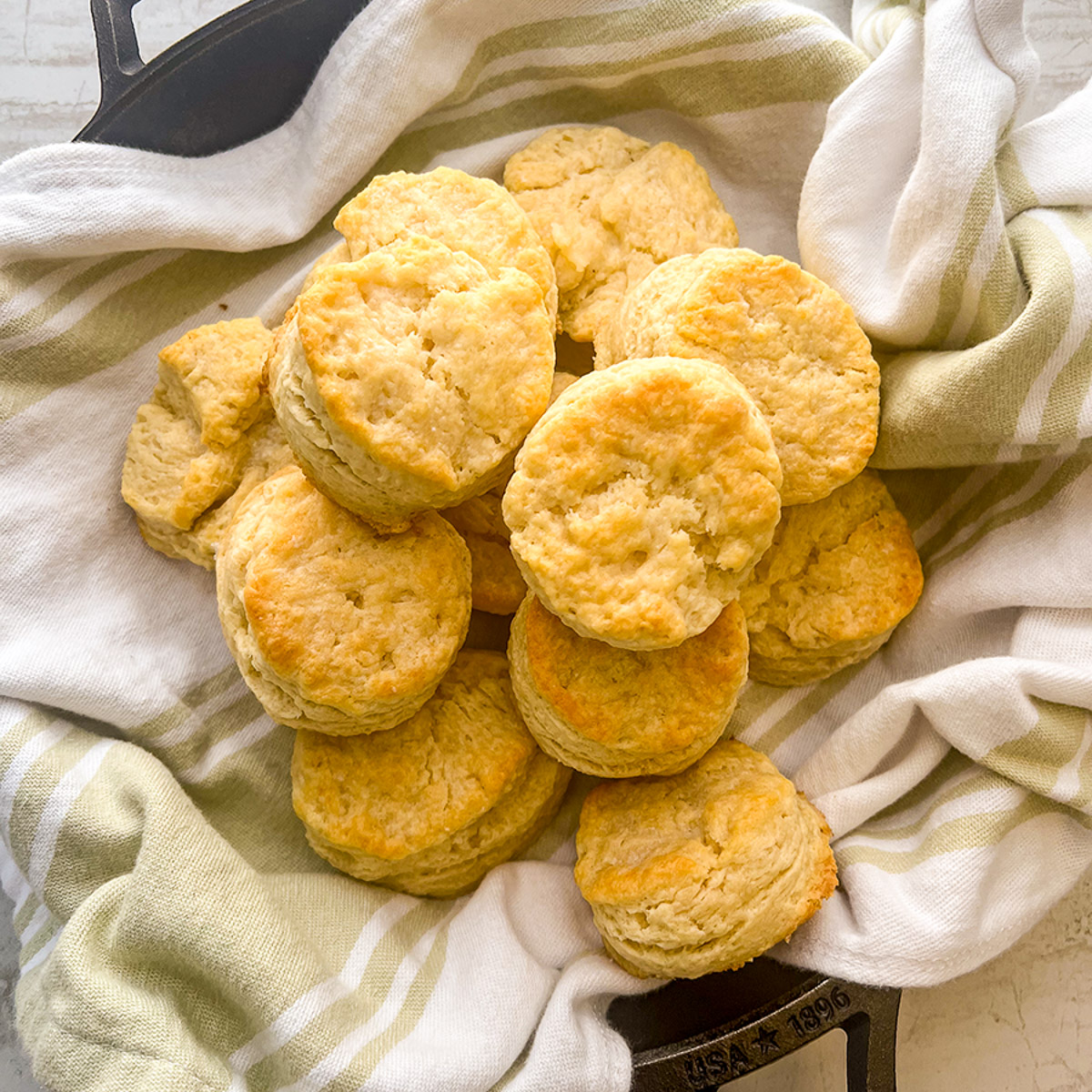 A plate of skillet buttermilk biscuits on the table.