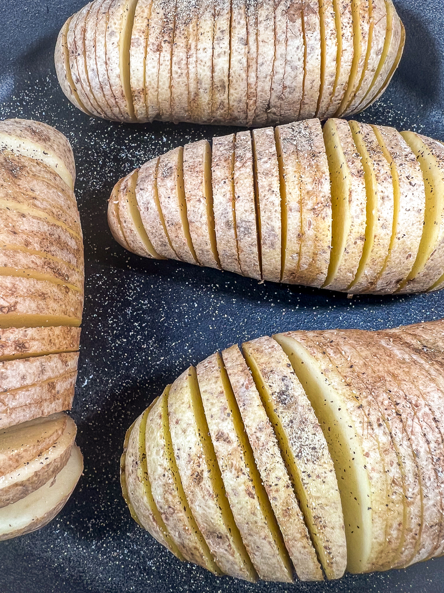While 'fanning' out the potato slices, salt and pepper has been sprinkled between the layers.