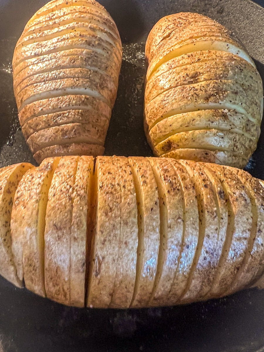 Seasoned and buttered potatoes roasting for about an hour in the oven.