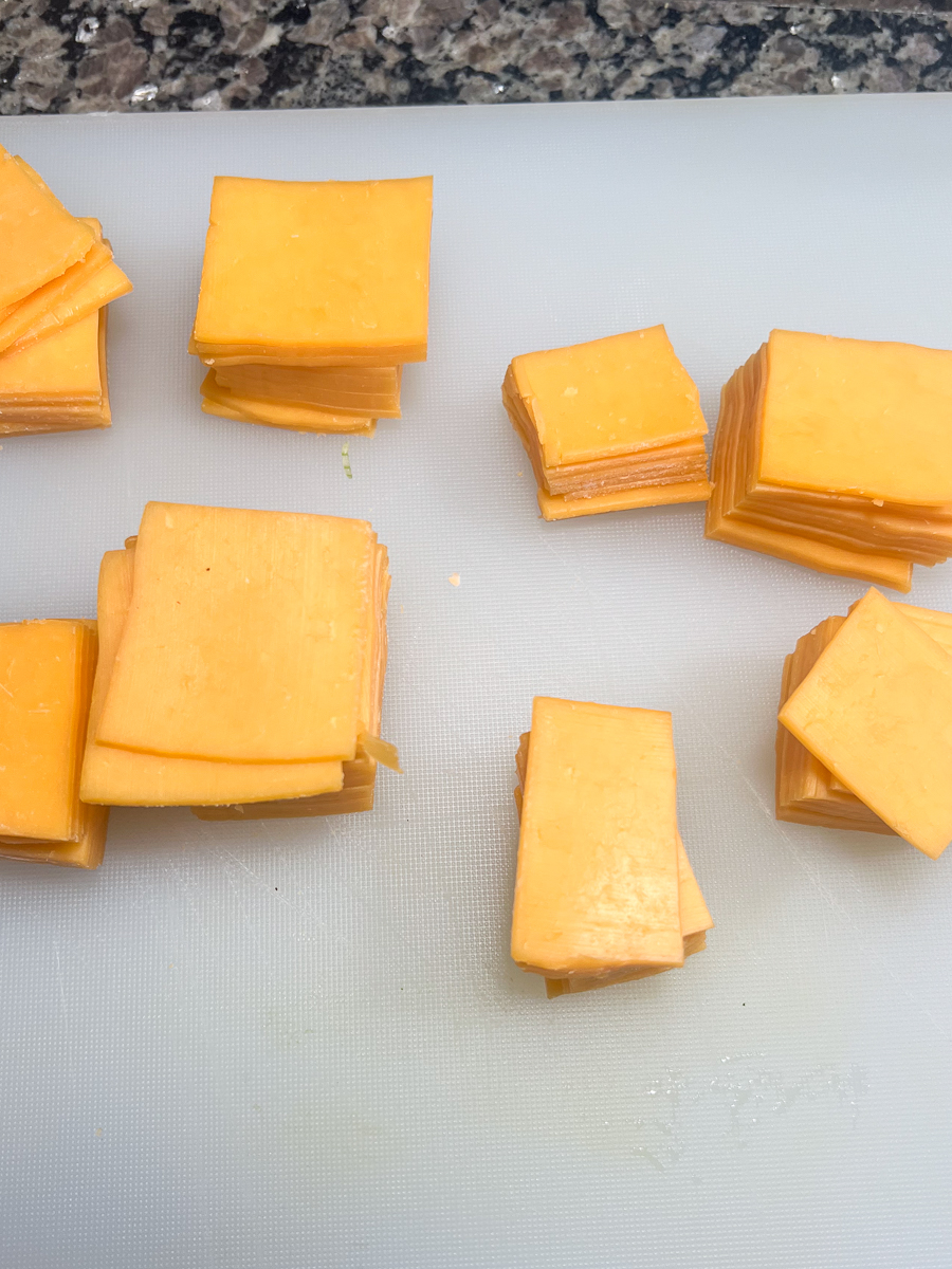Deli-style cheese cut into varying sizes to accommodate the width and length of the potatoes.