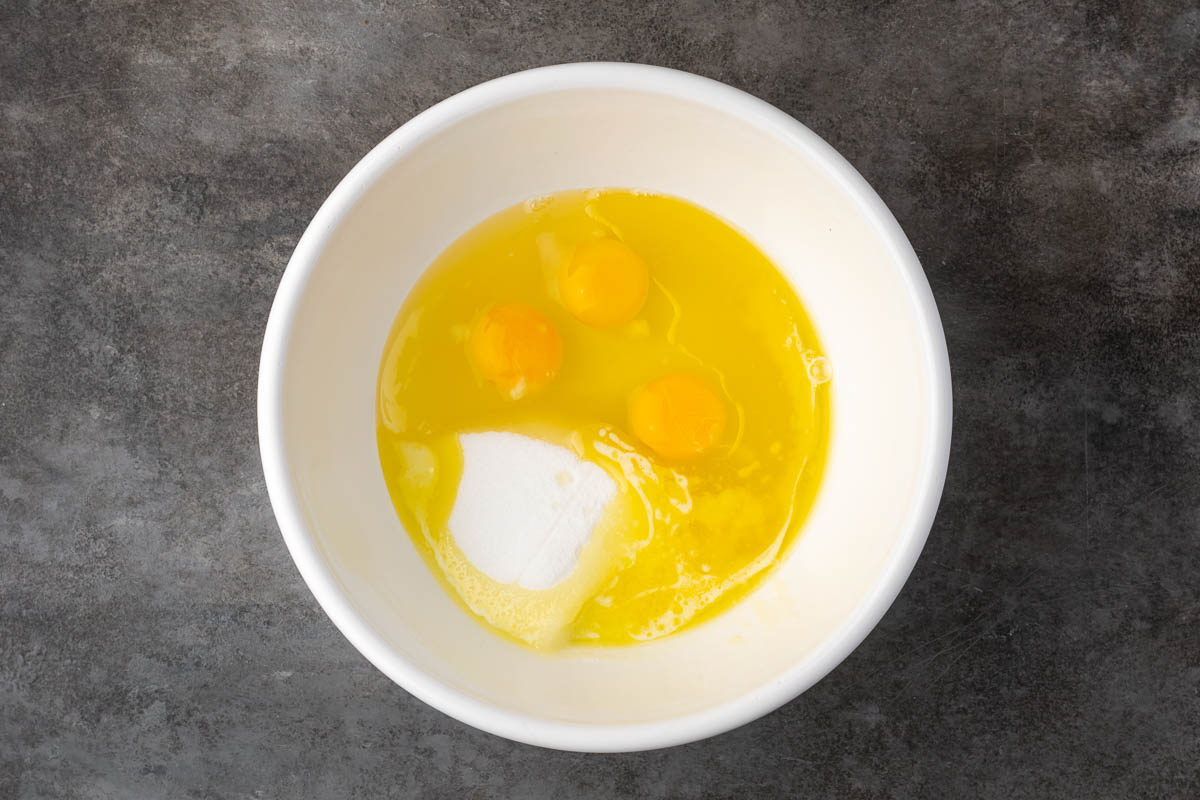 Egg and sugar in a mixing bowl.