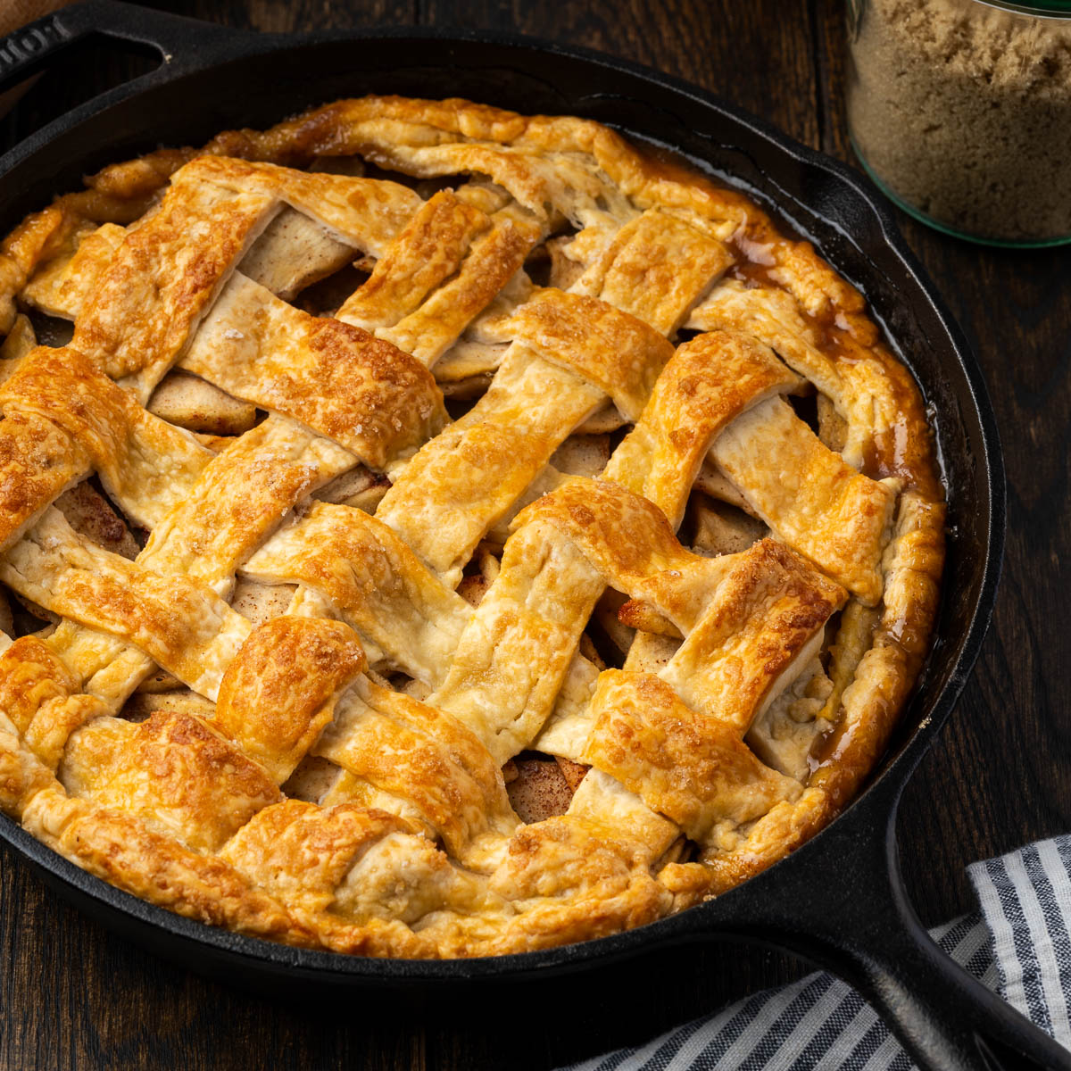 A cast iron skillet apple pie on the table.
