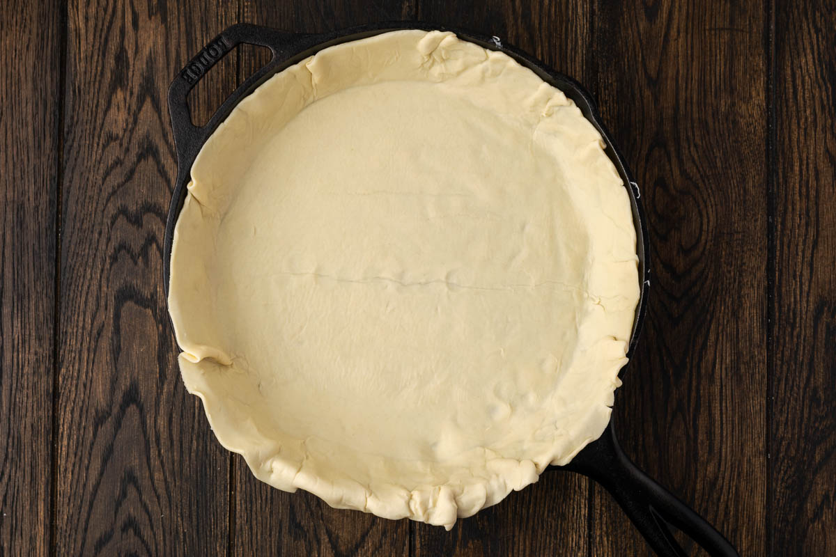 Bottom crust added to a pie plate.