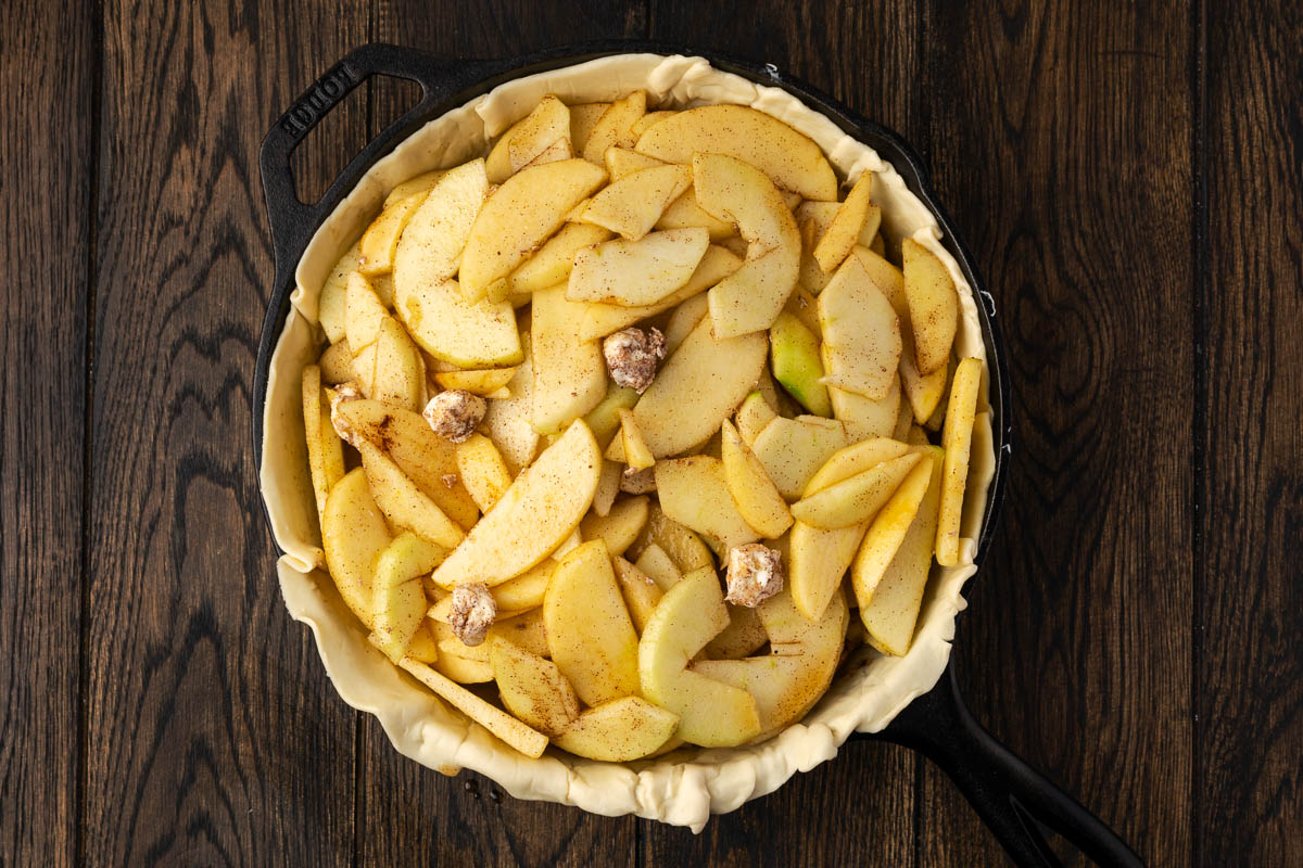 Sliced apples added to the pie crust.