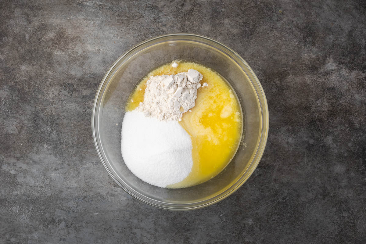 Butter, sugar, and flour in a mixing bowl.