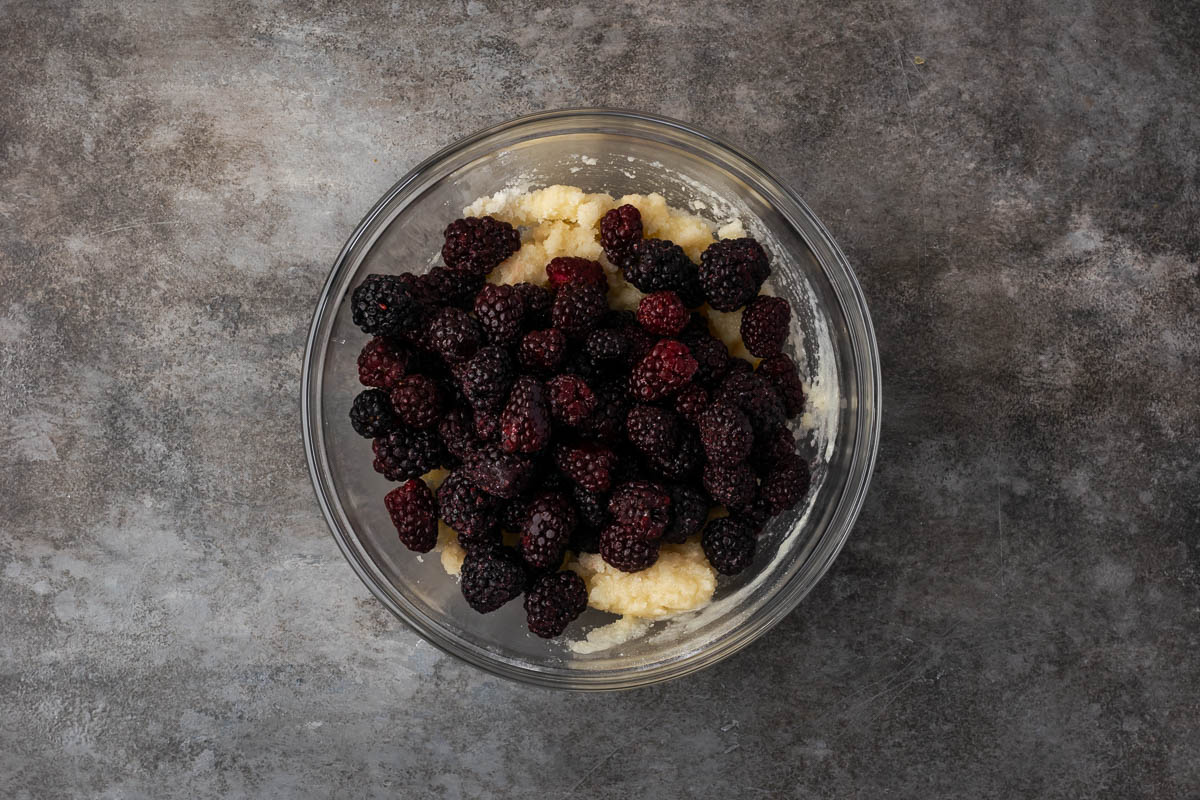 Berries added to the bowl of batter.