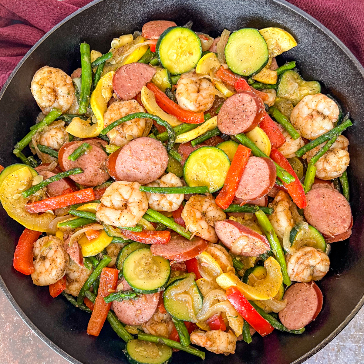 Cajun shrimp and sausage in a skillet.