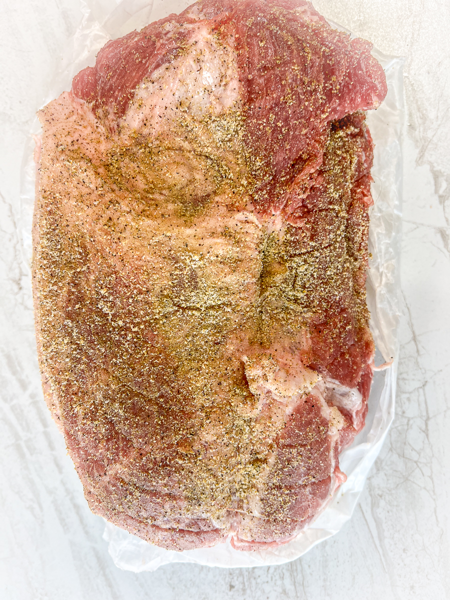 Pork roast with seasonings rubbed on.
