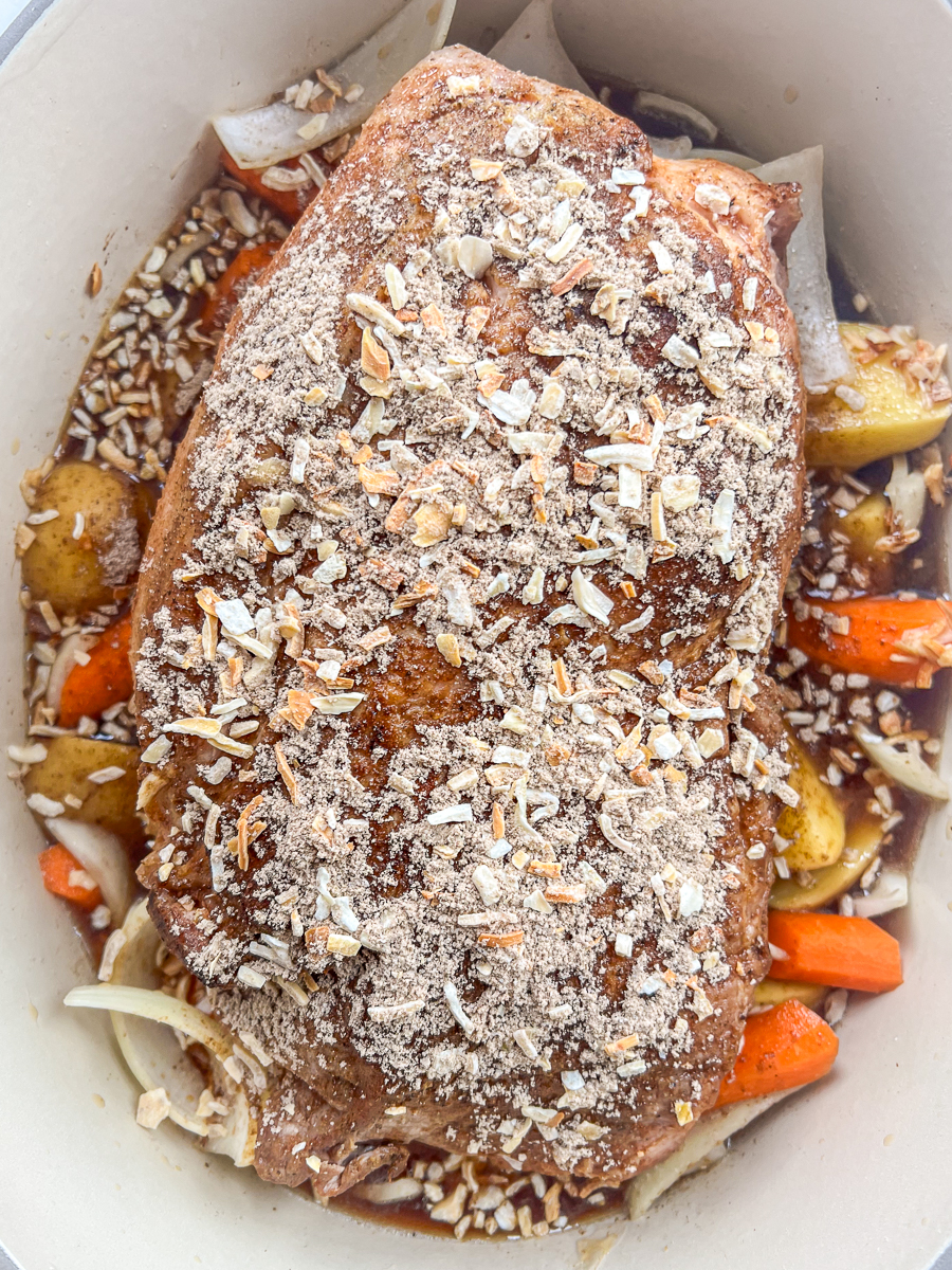 Broth and onion soup mix has been added to the dutch oven.