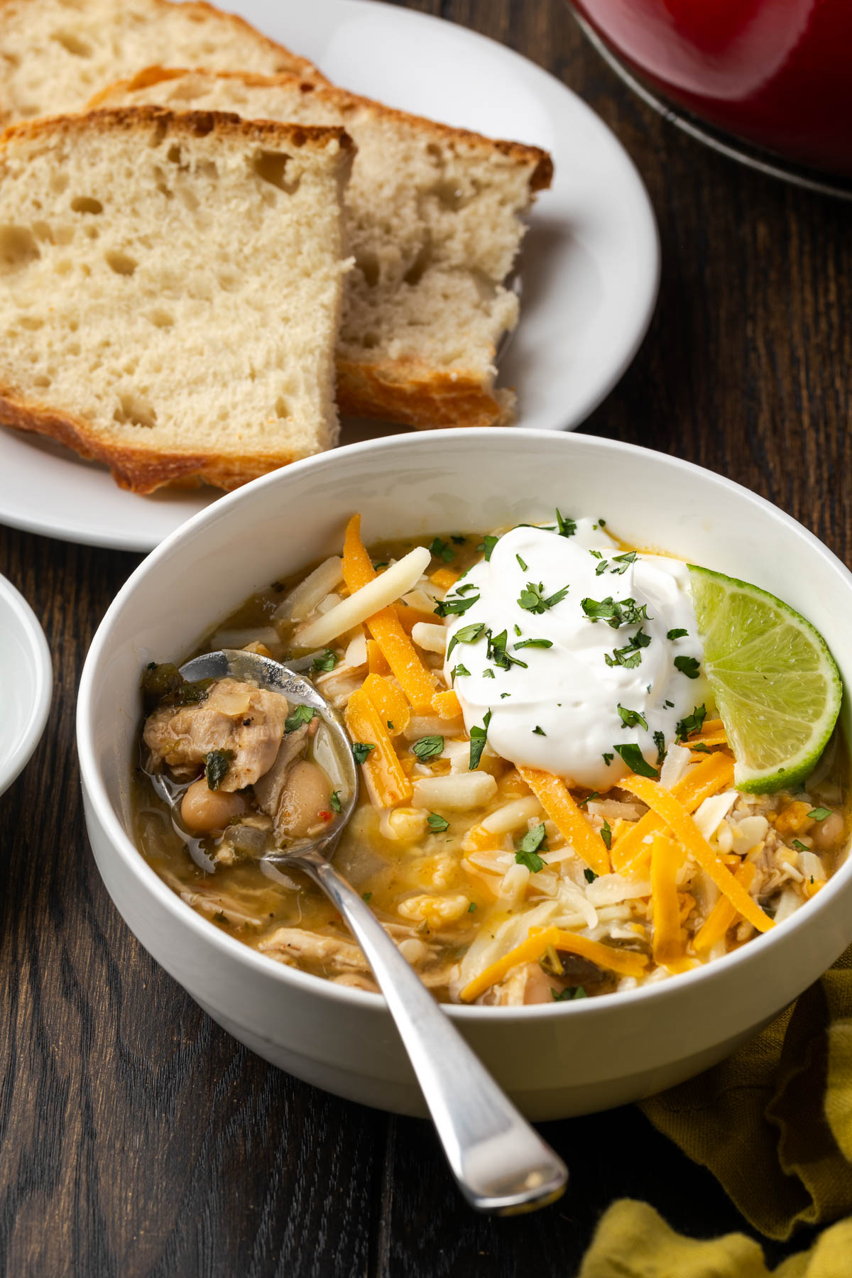 A bowl of Dutch oven white chicken chili with a spoon in the bowl.