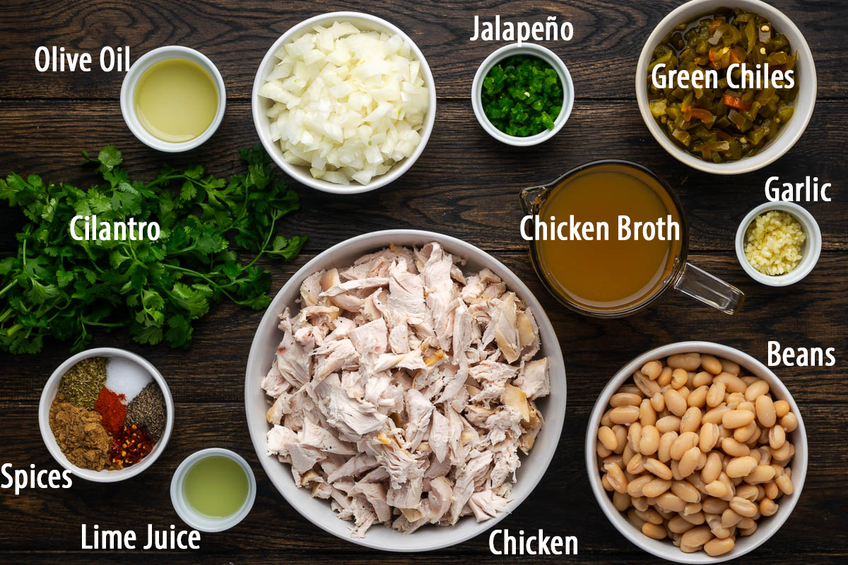 Ingredients to make white chicken chili on the table with text labels.