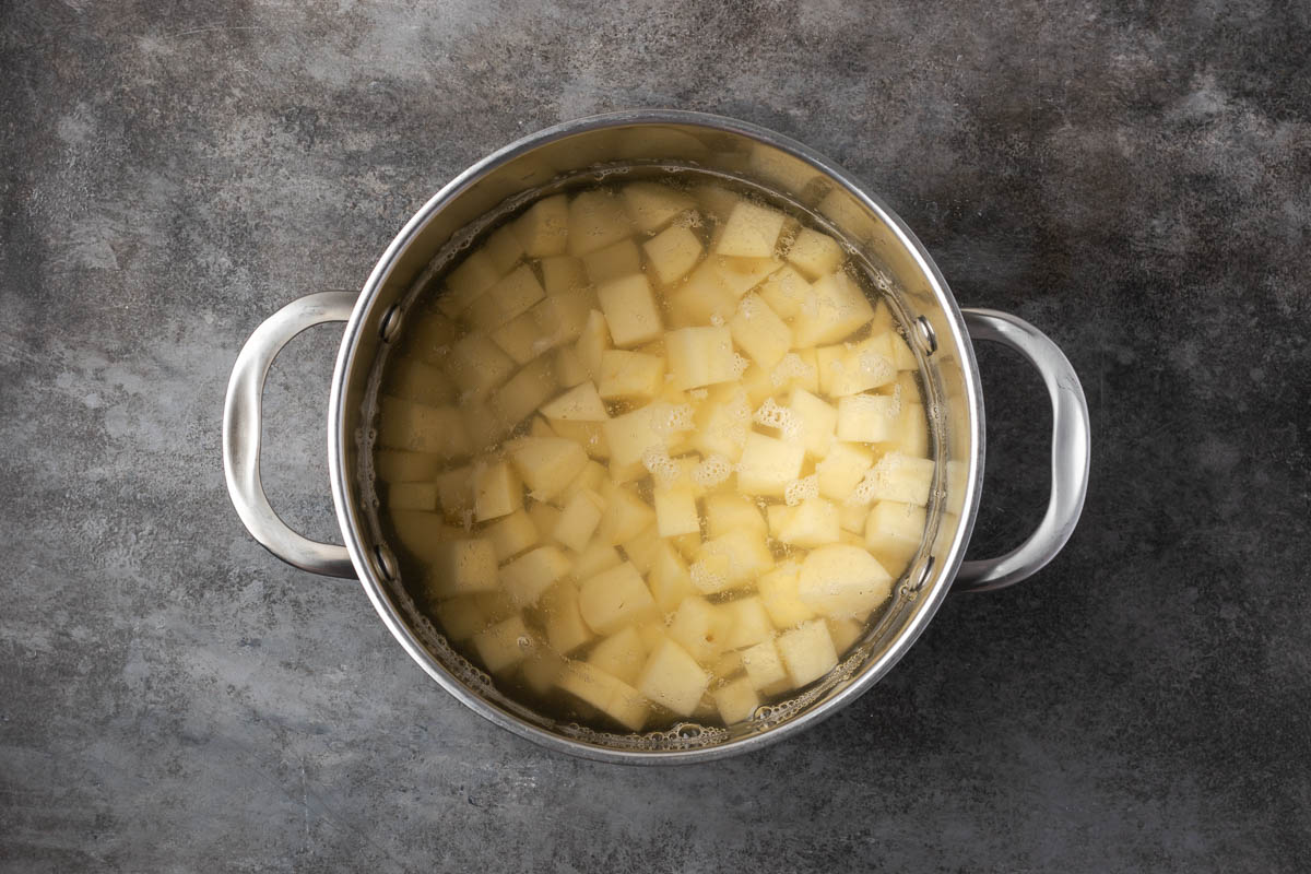 Potatoes and water in a pot to cook.