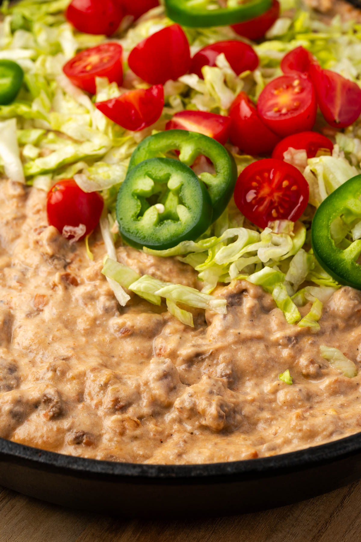 Nacho dip topped with fresh toppings.