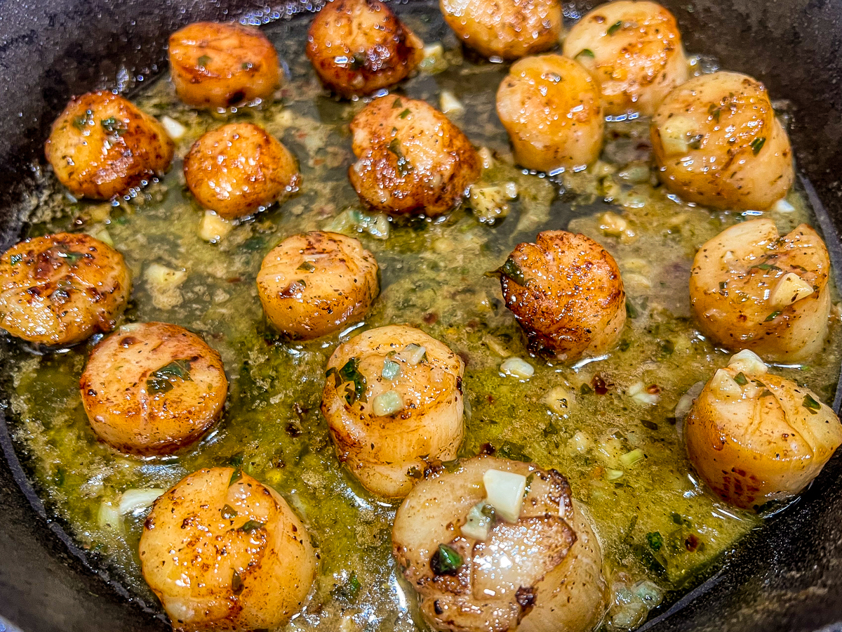 Scallops resting the hot lemon butter sauce.