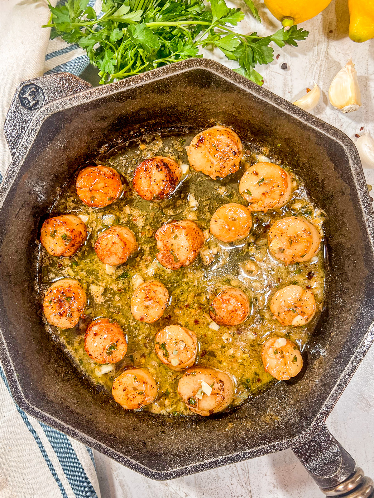 Pan seared scallops in a cast iron skillet with a lemon butter sauce.