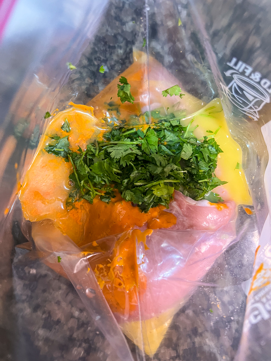Chipotle salsa, cilantro, orange juice, and the pork tenderloin inside a zip seal bag.