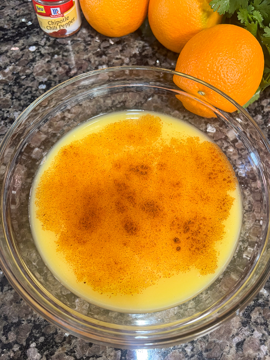 Chipotle powder and orange juice in a bowl.