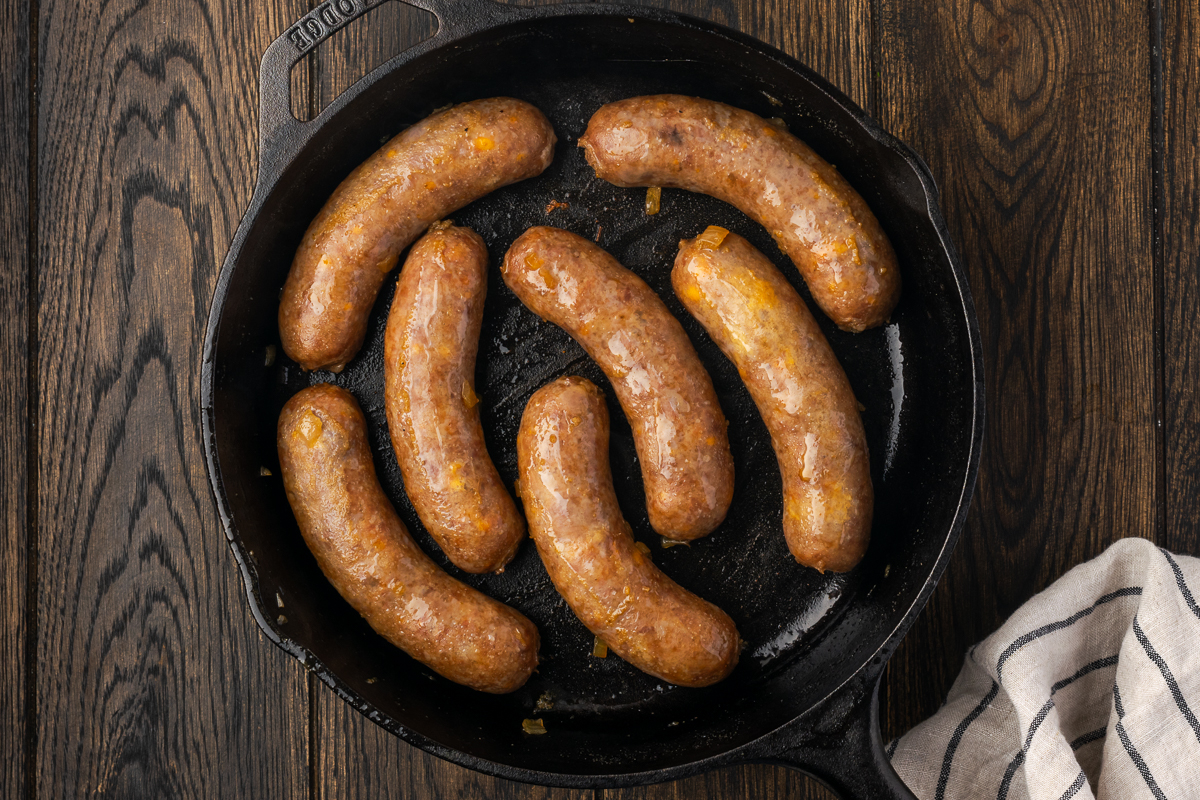 Beer brats added back to the skillet to sear.