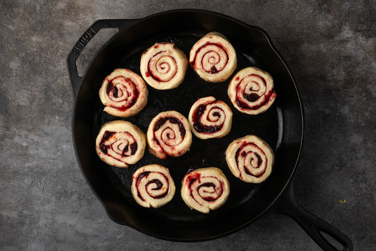Cherry rolls sliced and placed in a cast iron skillet.