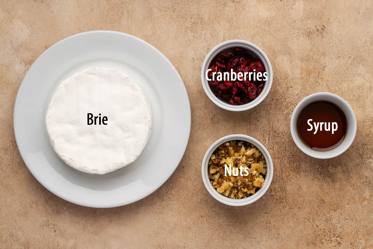 Ingredients to make a cranberry baked brie on a counter before assembling. 