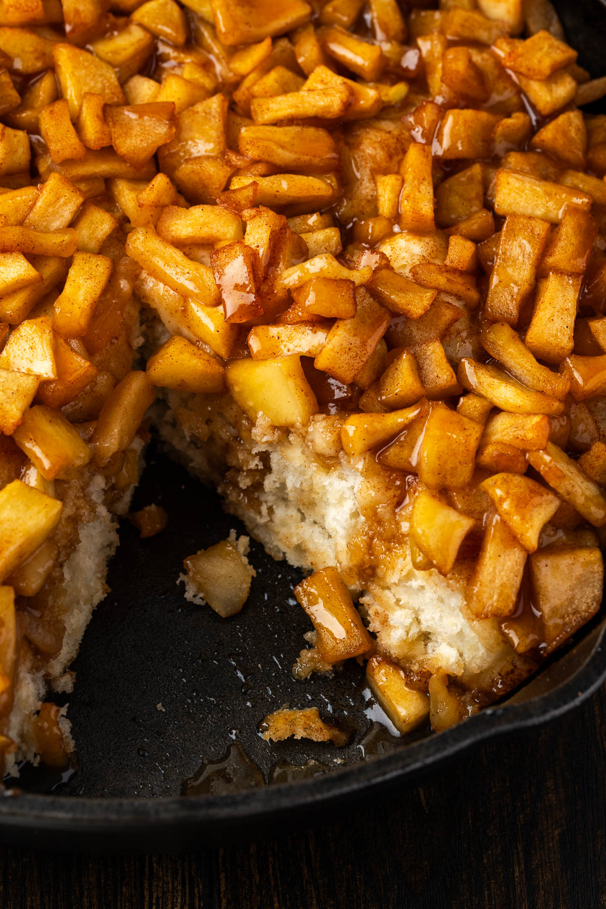 A skillet apple pizza with a slice missing.