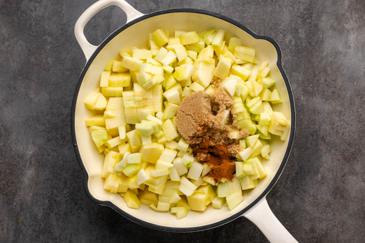 Apples and brown sugar added to a skillet.