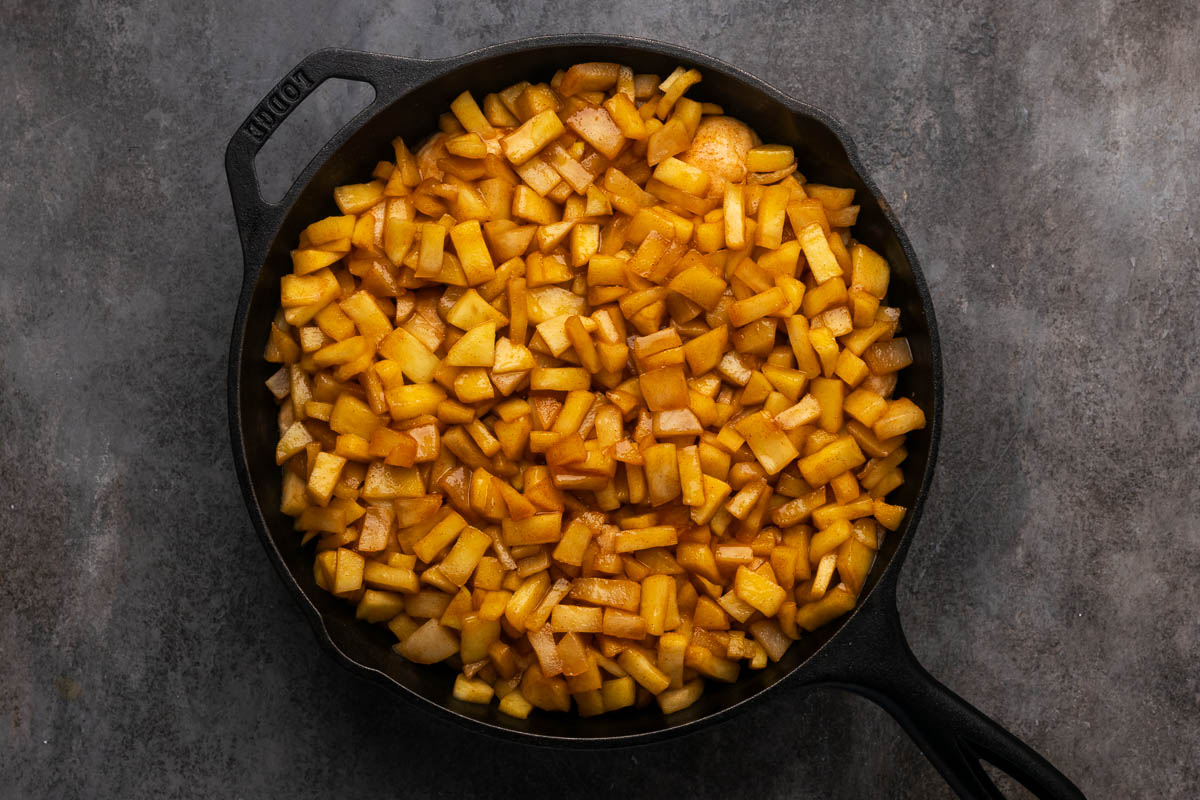 Apples added on top of the pizza dough.