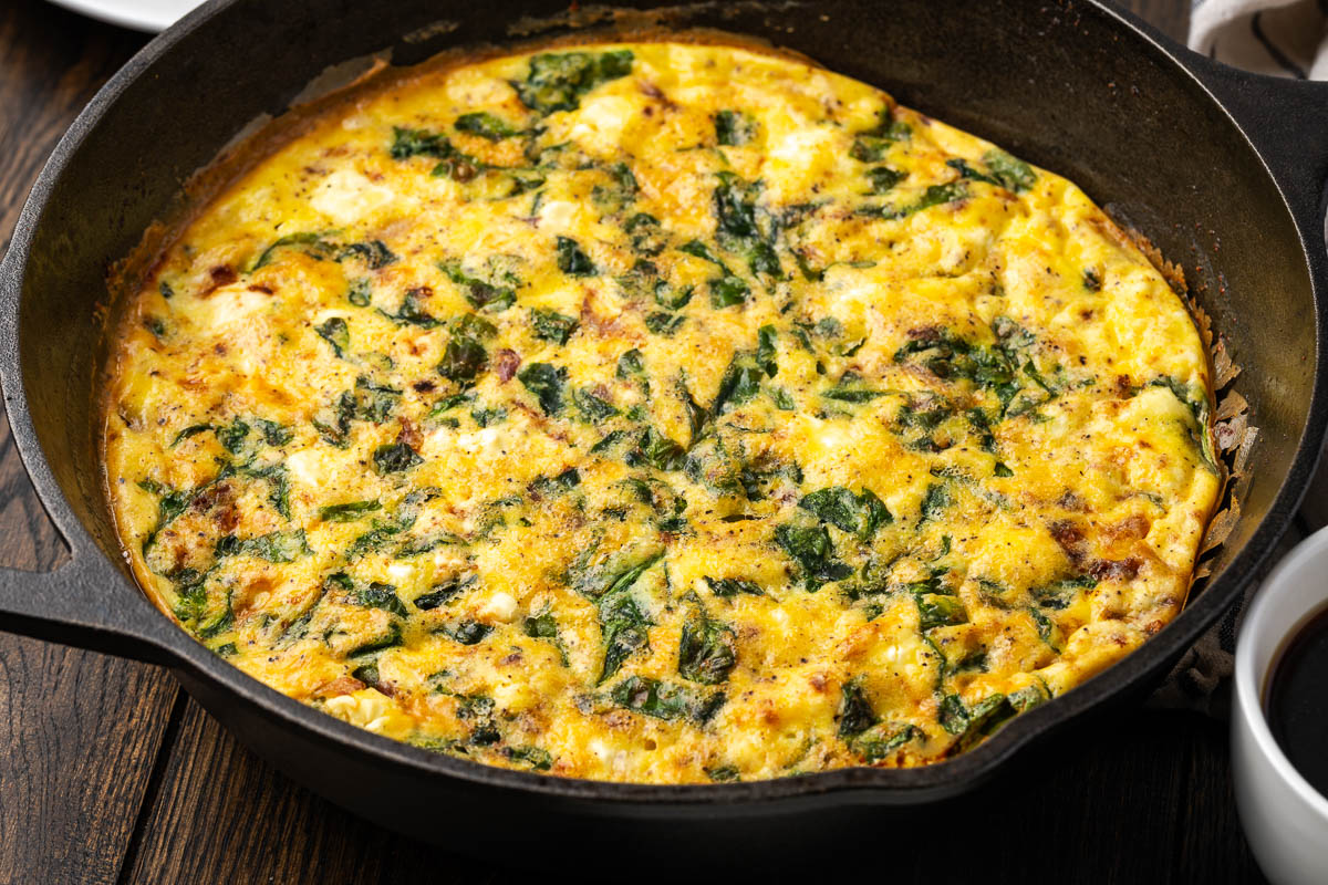Spinach frittata in a skillet after baking. 