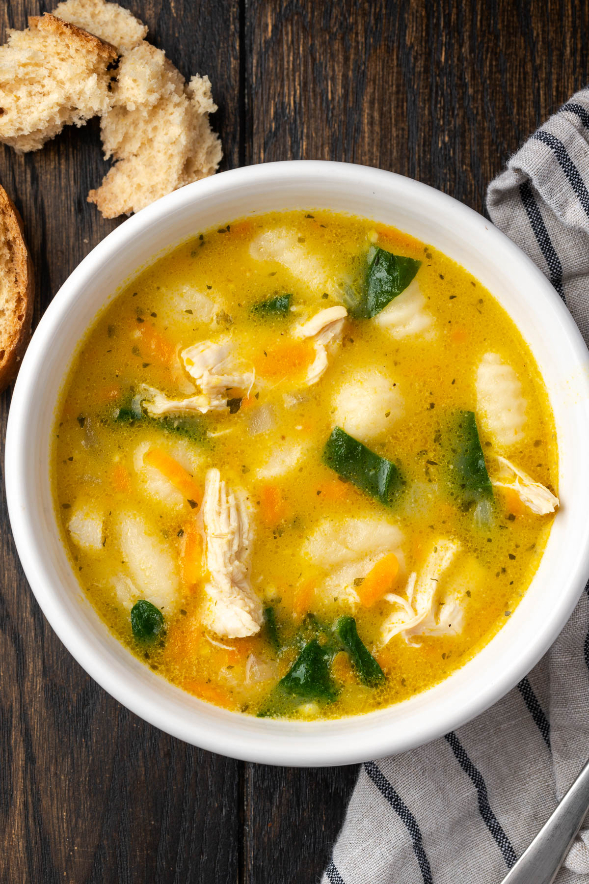 A bowl of creamy chicken gnocchi soup.