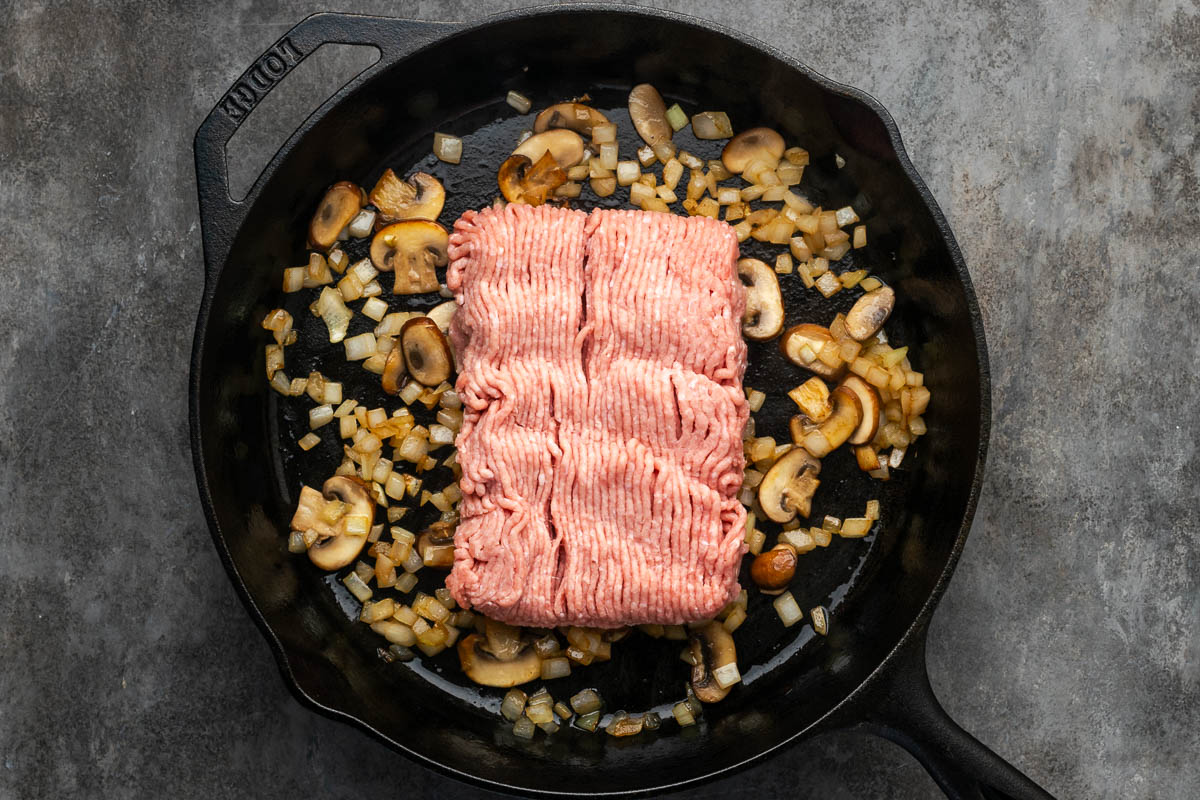 Ground turkey added to the skillet with the mushrooms and onions.