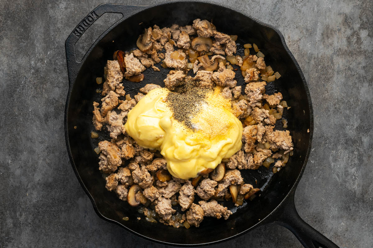 Stroganoff sauce ingredients added to the skillet.
