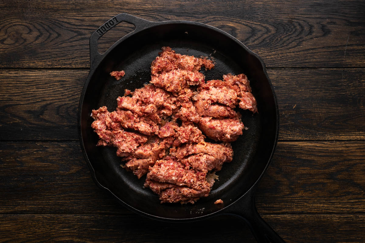 Sausage cooking in a skillet.