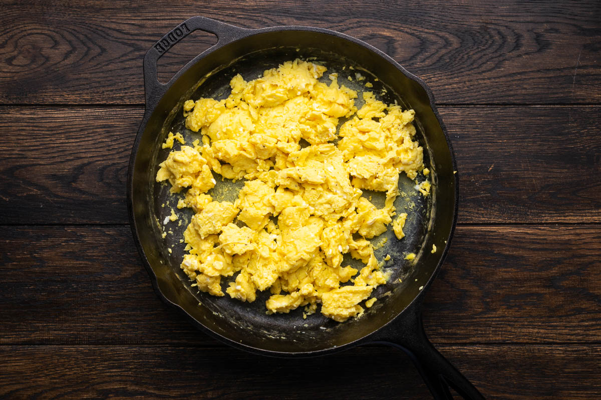 Cooked scrambled eggs in a skillet.