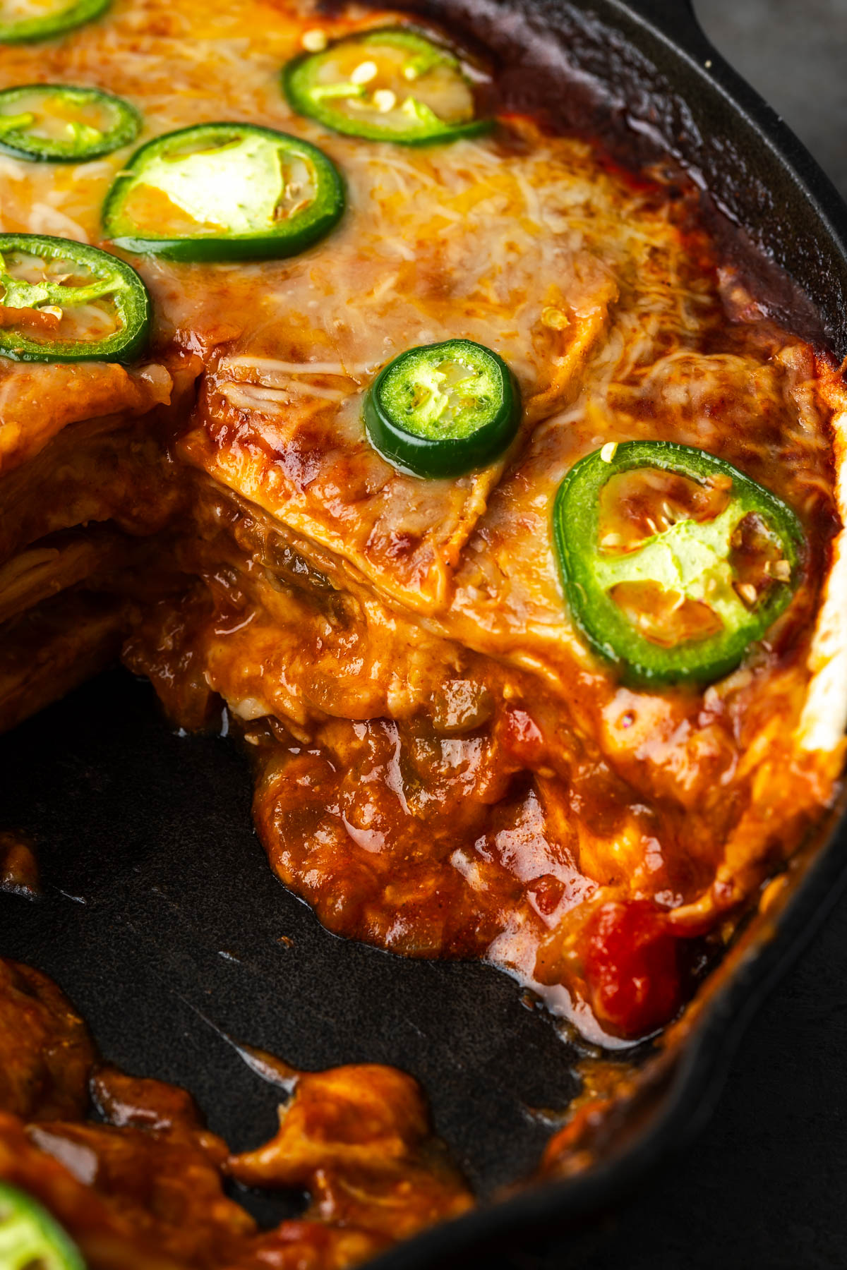 Enchilada skillet with a portion missing to show layers inside.