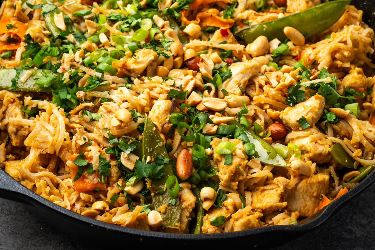 Peanut chicken stir fry in a skillet after cooking. 