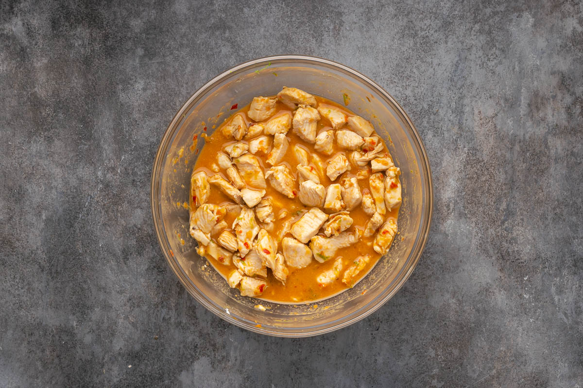 Chicken in a bowl with the stir fry sauce. 