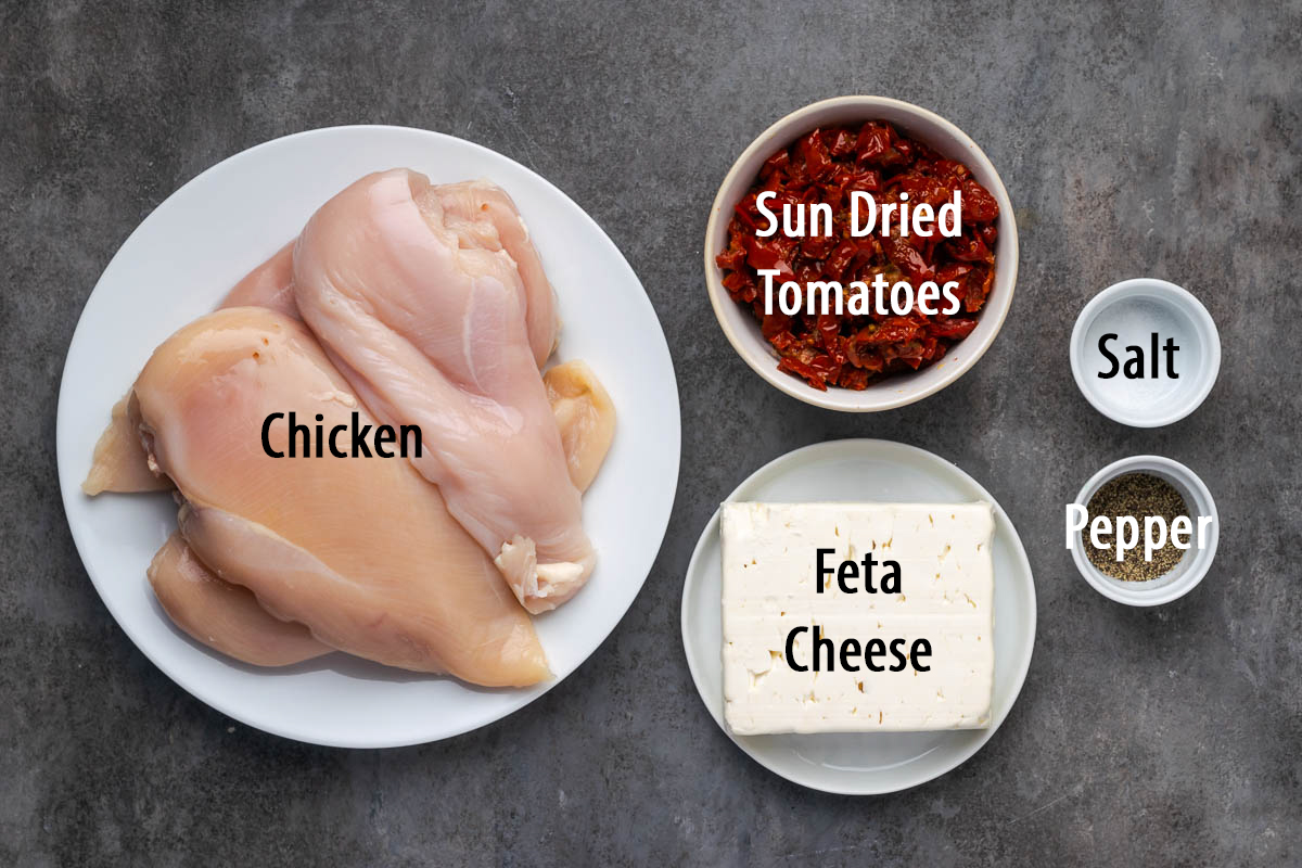 Ingredients to make sun dried tomato stuffed chicken breasts on a counter. 