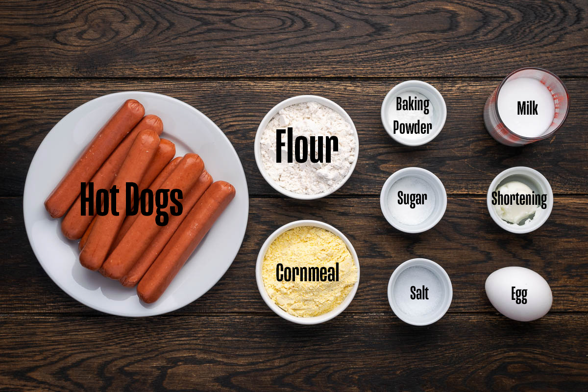 Ingredients to make mini corn dogs on the table in bowls.