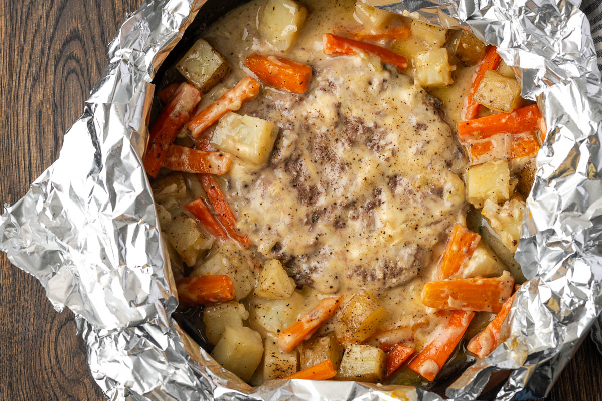 Foil wrapped around a skillet to cook it in a campfire. 