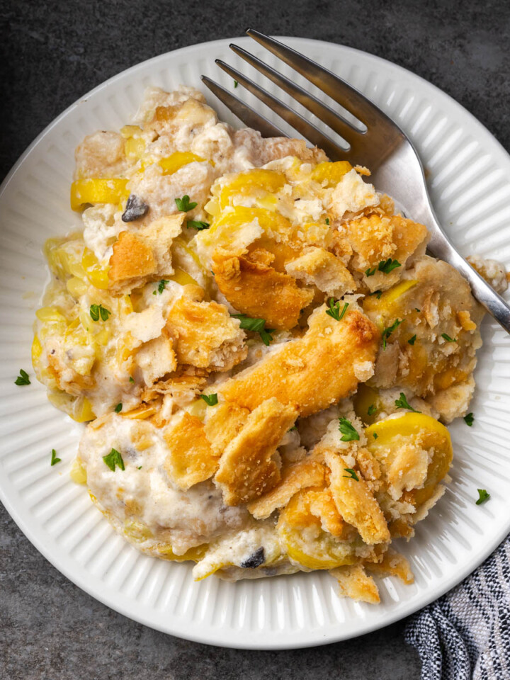 Summer squash casserole on a plate with a fork resting on the side.
