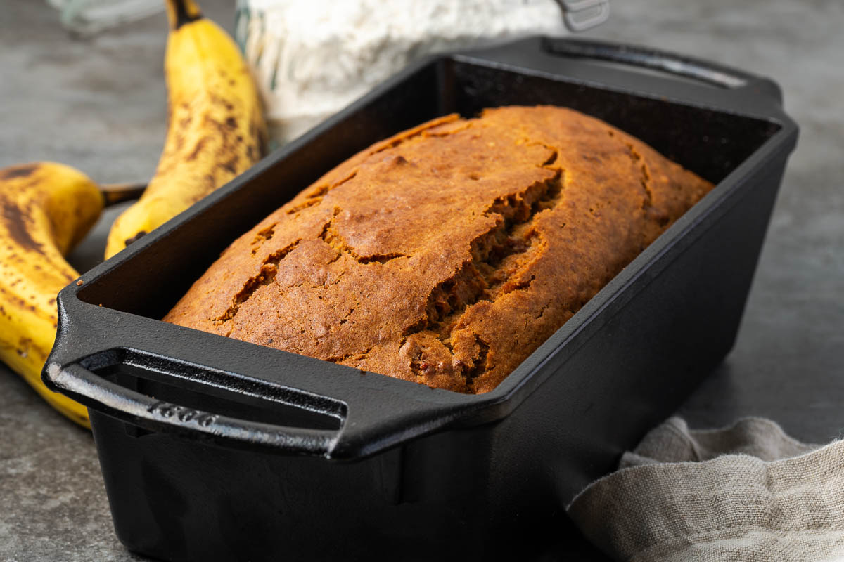 Banana bread with bacon baked in a loaf pan.