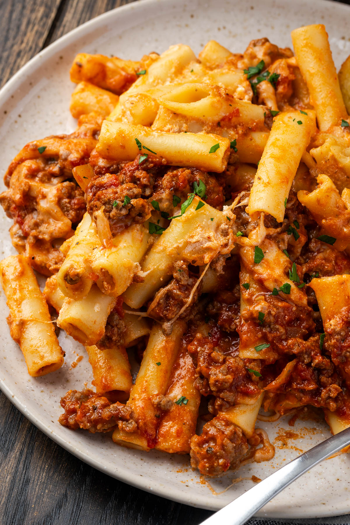 Baked ziti with meat sauce on a plate.