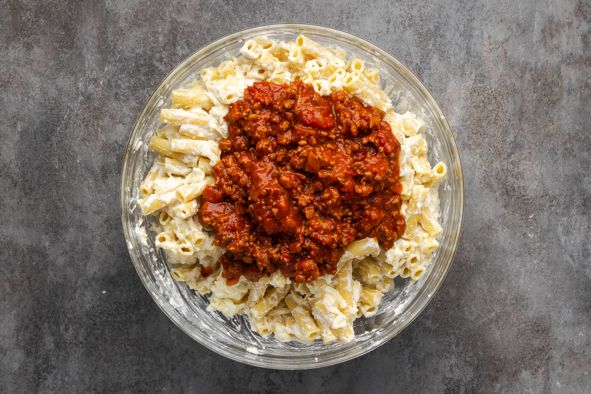 Pasta mixed with the cheese mixture and meat sauce added.